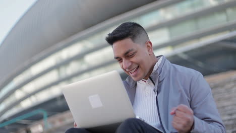 Smiling-handsome-young-man-using-laptop
